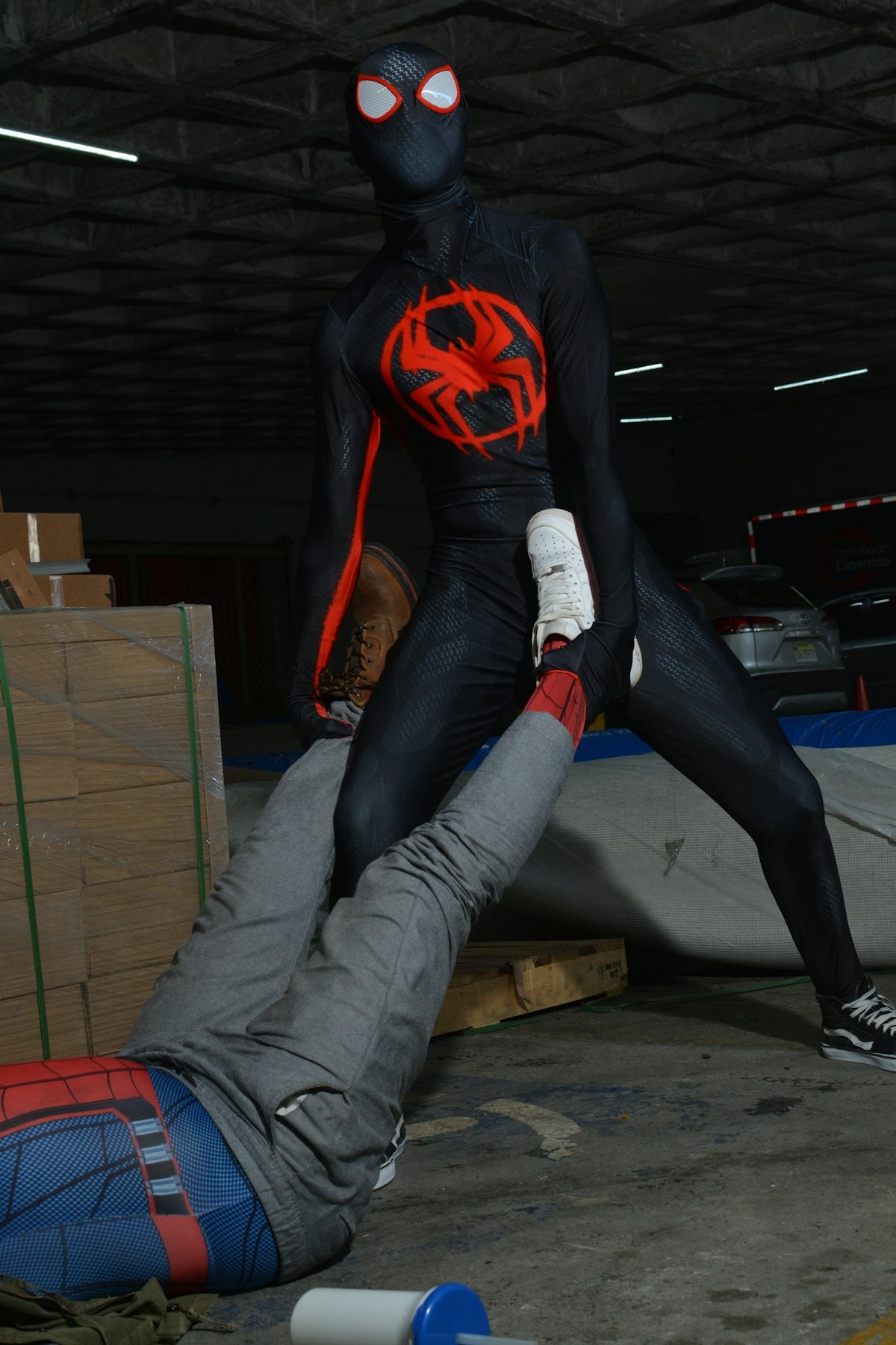 a man in a spider man costume laying on the ground