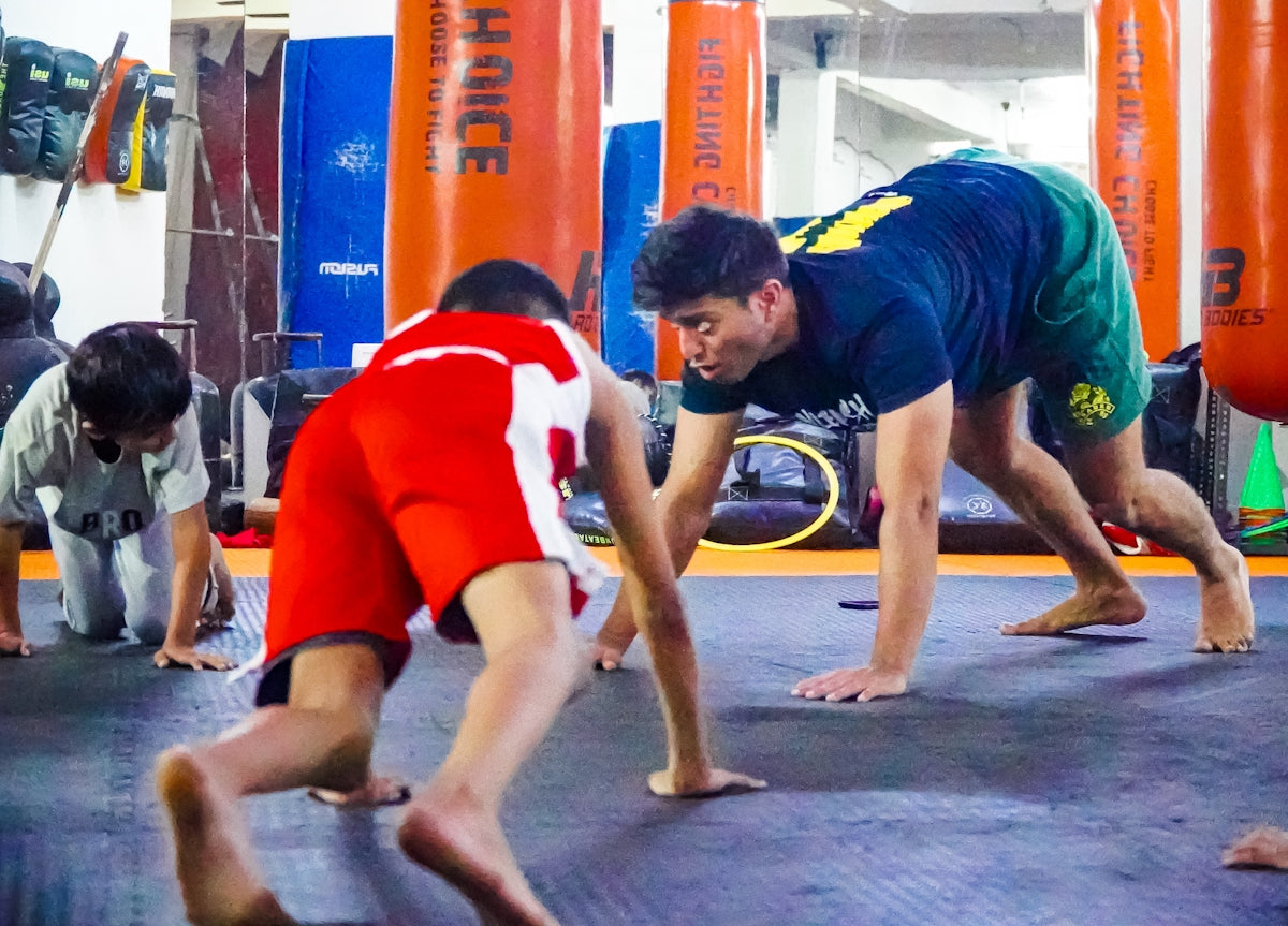 a group of men standing on top of a gym floor