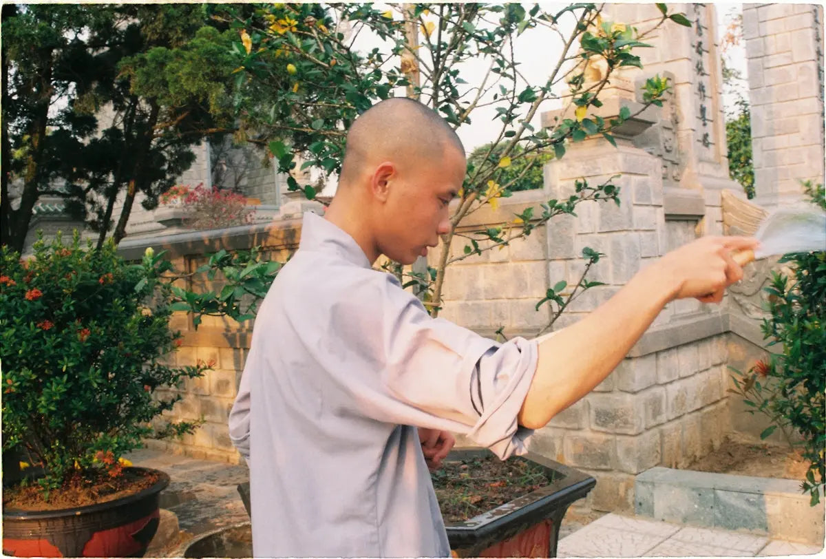 man holding feather duster