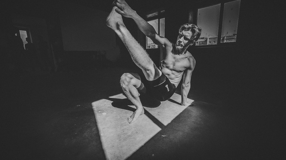 topless man in black shorts doing push up