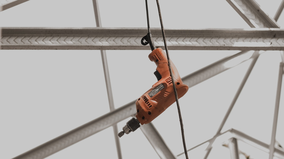 a pair of drillers hanging from a metal structure