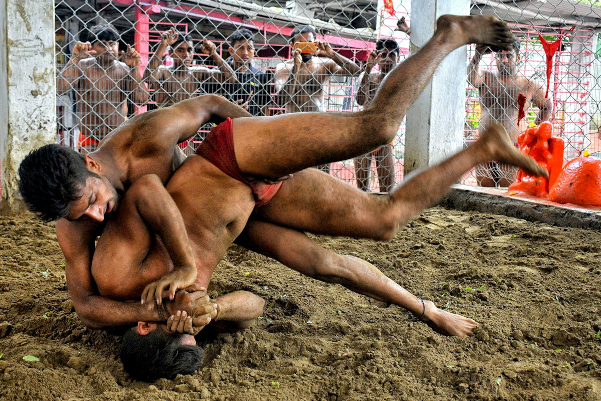 a couple of men wrestling