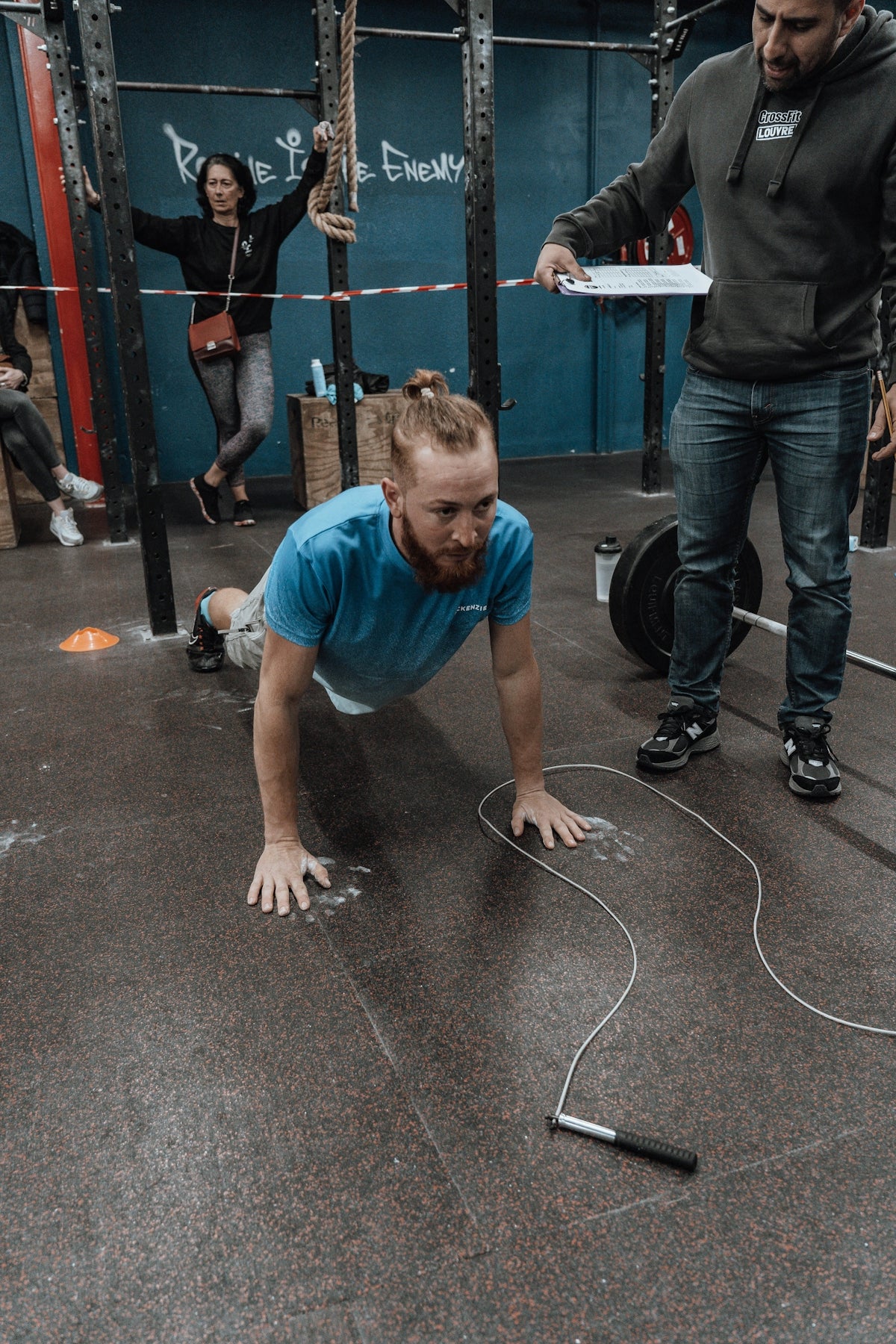 a man doing push ups on a gym floor
