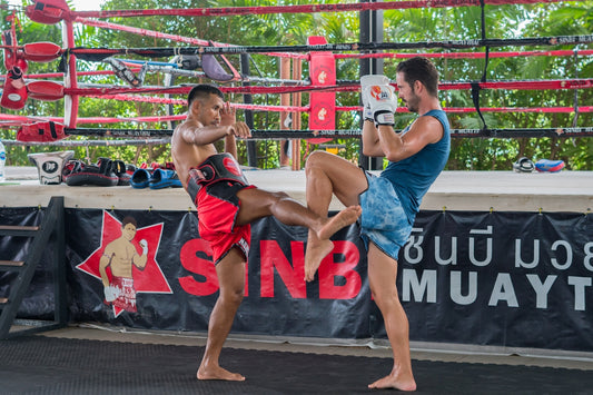 a couple of men standing next to each other in a boxing ring