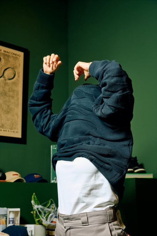 a man standing in a room with his hands in the air