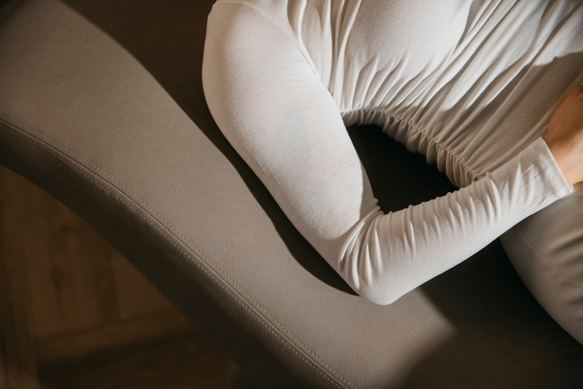a woman sitting on a couch with her arms crossed