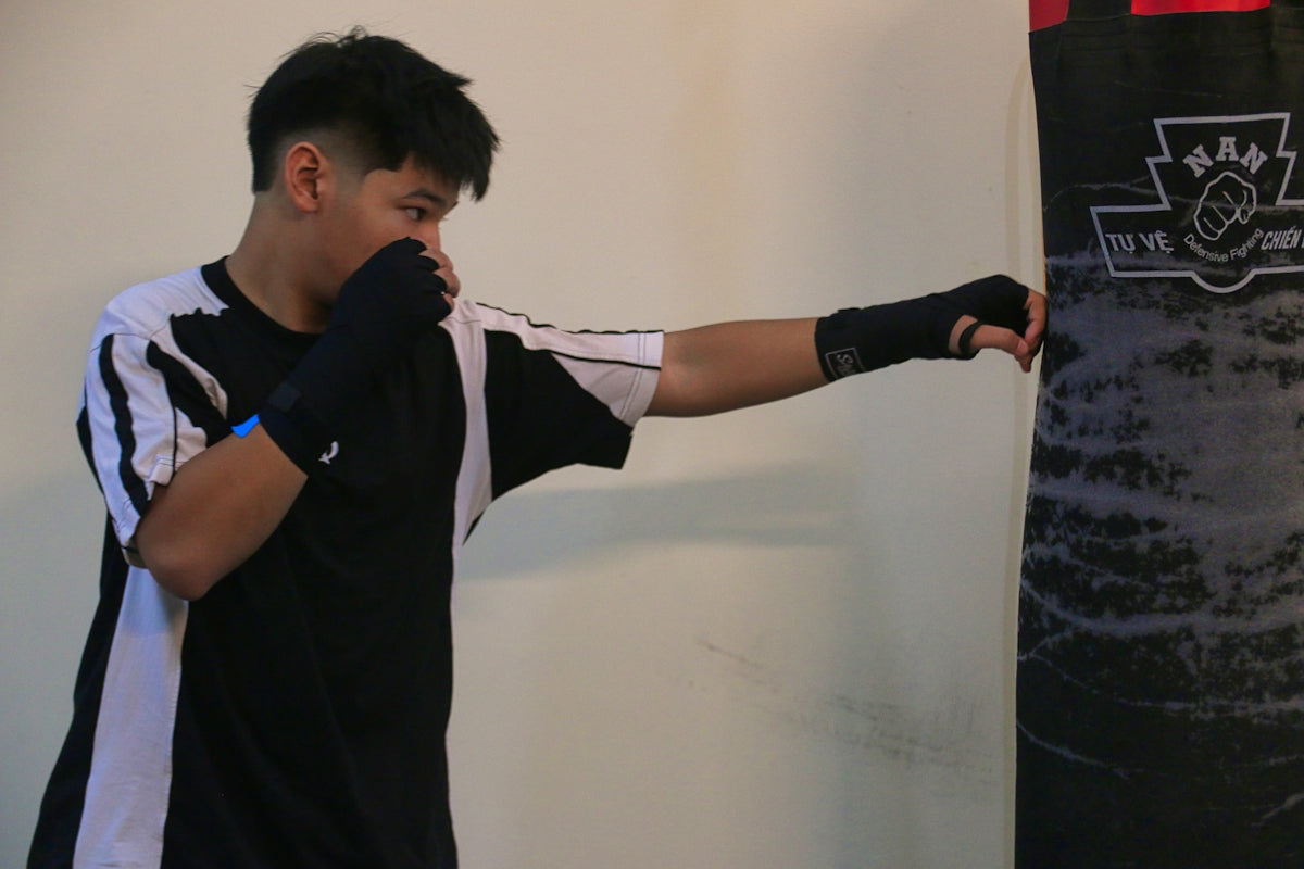 a young man is practicing his boxing moves