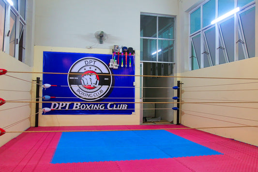 a boxing ring with a blue mat in the middle of it