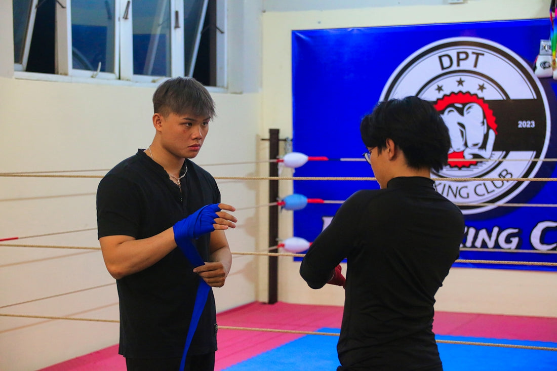 a man standing next to a woman in a boxing ring
