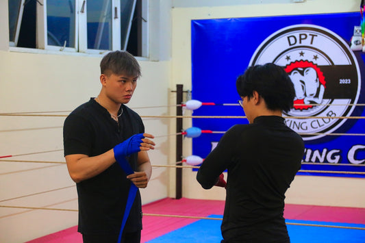 a man standing next to a woman in a boxing ring