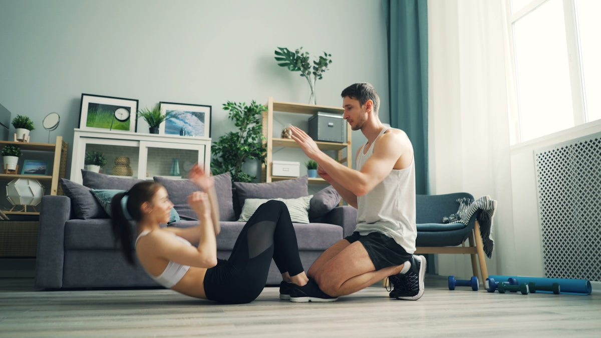 a man and woman sitting on the floor in a living room