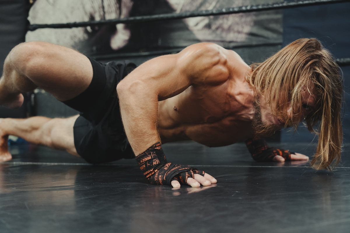 A man doing a handstand on a wrestling ring