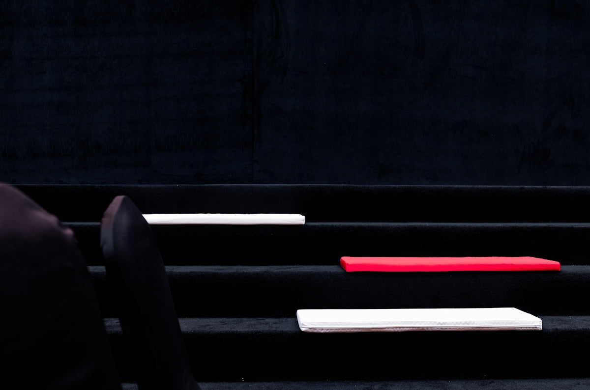 Colored rectangles rest on black steps.