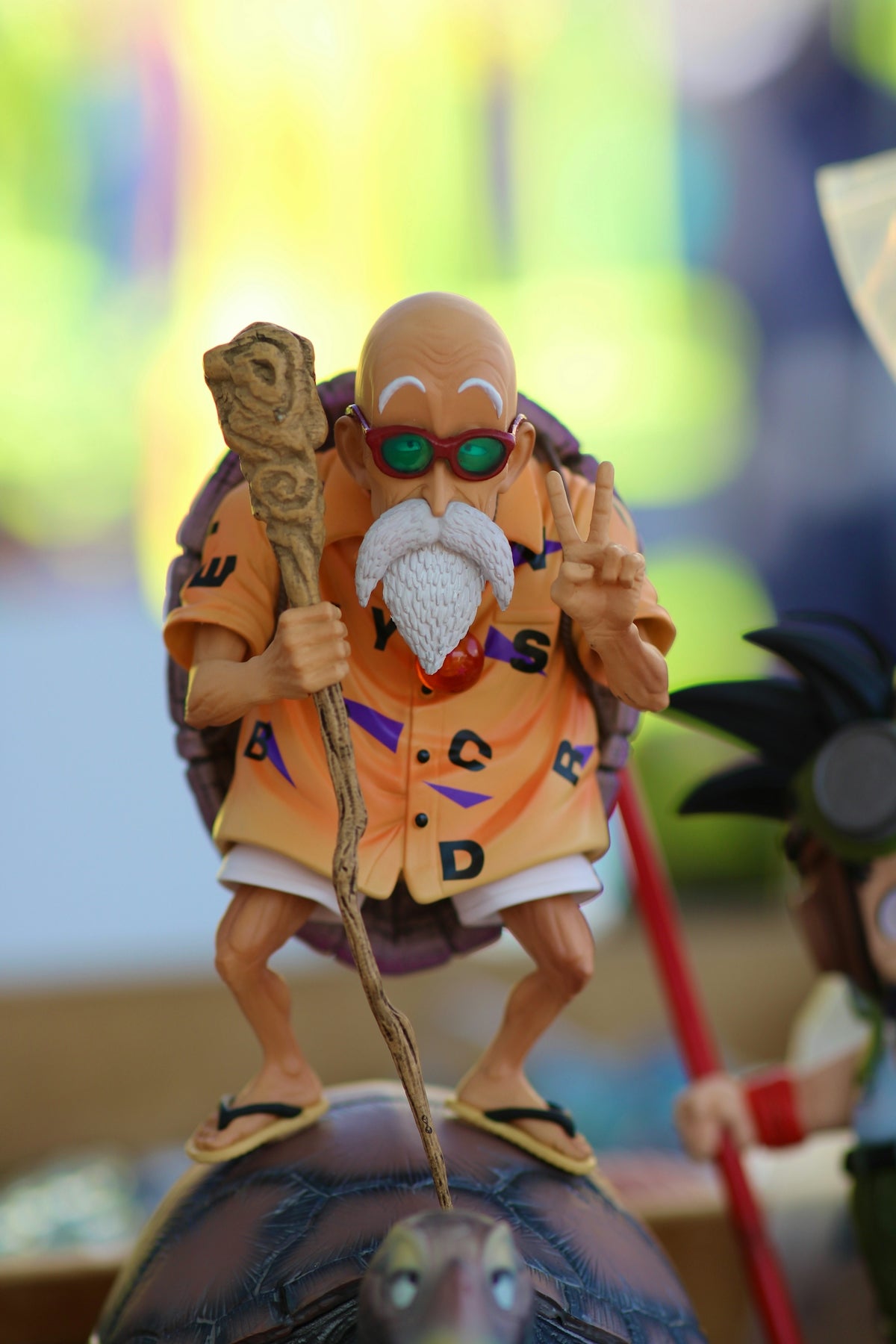 Master roshi figure with staff and sunglasses